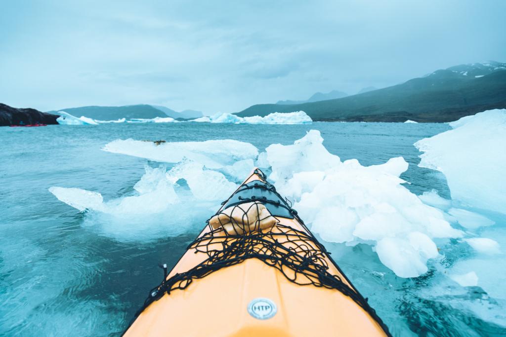 Kayaking among blue icebergs in South Greenland